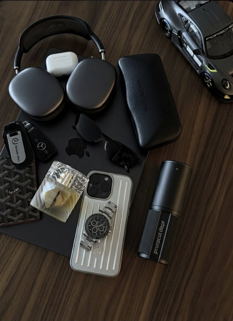 The Instrument in an everyday carry flat-lay with luxury goods